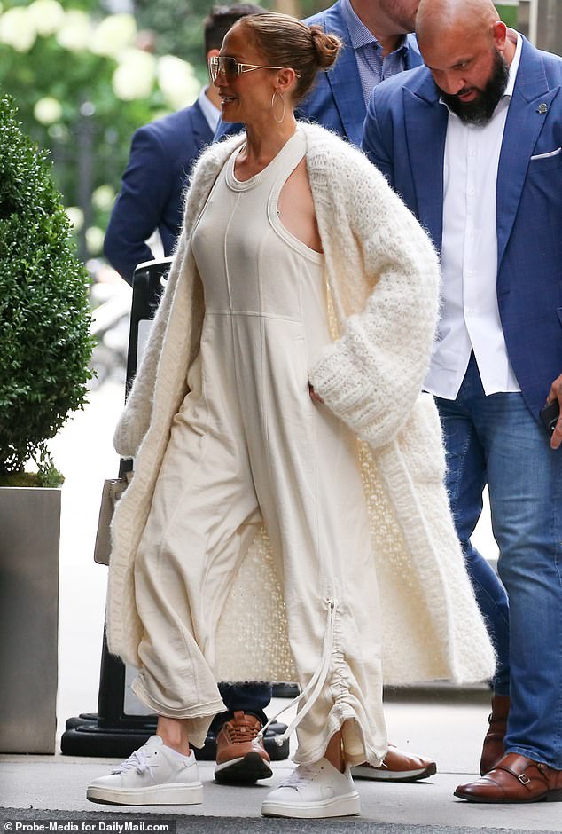 Lopez accessorized the travel ensemble with a matching furry ankle-length cardigan with long, billowy sleeves.