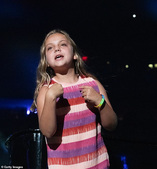 Della looked cheerful as she sang alongside her father during My Life in her chic mini dress.