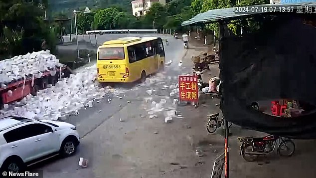 Hundreds of beer cans can be seen spilled on the road.