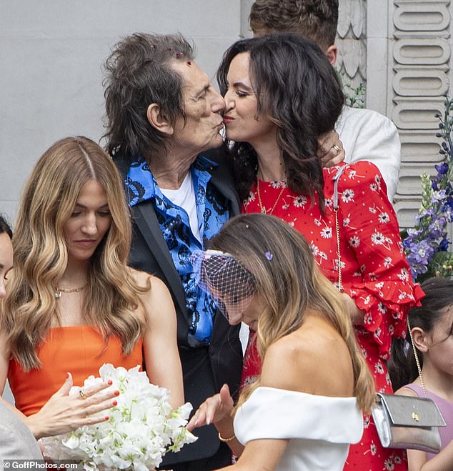 Ronnie, 77, wore a dark suit over a vibrant blue shirt as he celebrated and kissed his stunning wife Sally, 46.