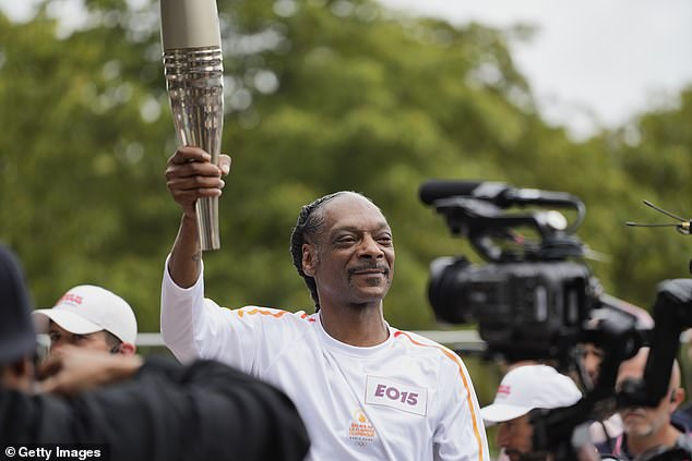 1721998536 258 Snoop Dogg carries the Olympic torch ahead of the opening