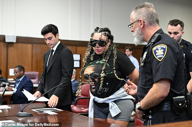 Clifford was then handcuffed and led out of the courtroom, but not before giving the middle finger to the press in attendance and taking pictures.