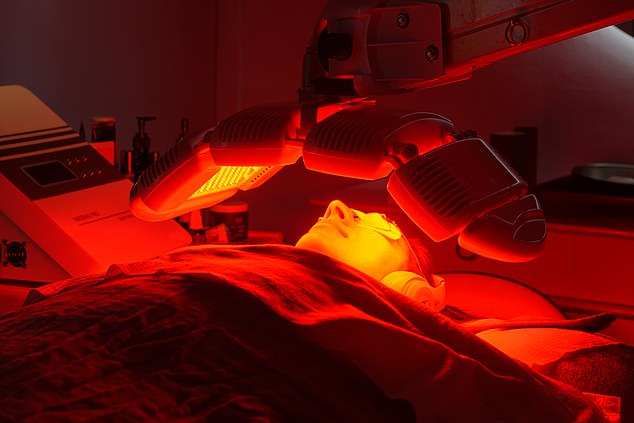 The facialist uses an LED light therapy device on Radhika's skin to boost collagen.