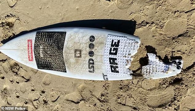 Mr McKenzie's surfboard is pictured after the horrific shark attack at North Shore Beach in Port Macquarie on Tuesday morning.