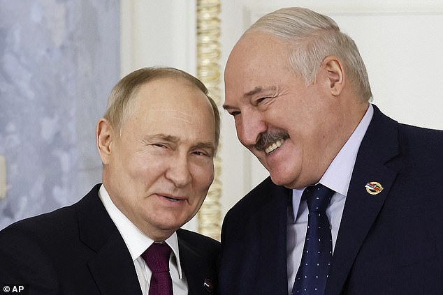 Vladimir Putin pictured with Belarusian President Alexander Lukashenko, right, during a meeting of the Supreme Council of the Union State in St. Petersburg, Russia, earlier this year