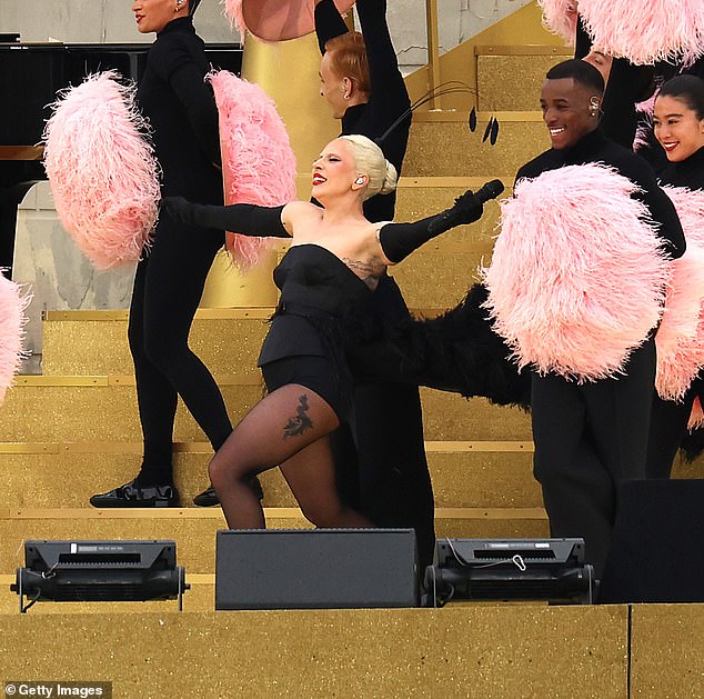 She was joined by a host of dancers dressed in black and waving pink feathers during the spectacular performance.