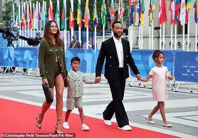 Chrissy Teigen put on a leg-splitting display as she joined husband John Legend and their children Luna, 8, and Miles, 6, at the Olympic Opening Ceremony.