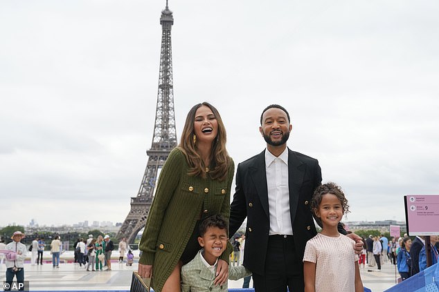 Chrissy showed off her toned tummy in a long cardigan that she wore with half of the buttons undone.