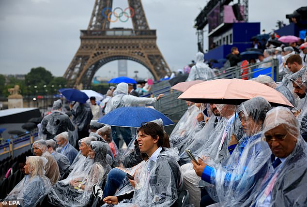 Torrential rain in Paris has marred the opening ceremony and many spectators were seen wearing ponchos and holding umbrellas.