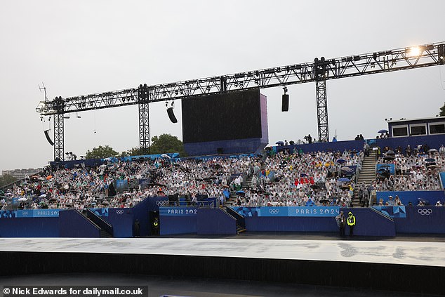 A screen at the Trocadero breaks due to the onslaught of rain