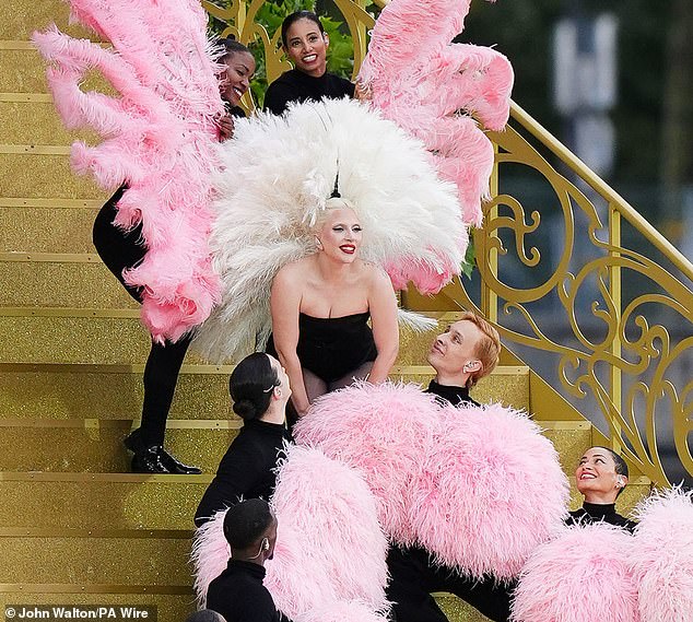 The 38-year-old Bad Romance star dazzled in a black leotard and white feathers as she graced the international stage with her performance of Mon Truc in Plumes.