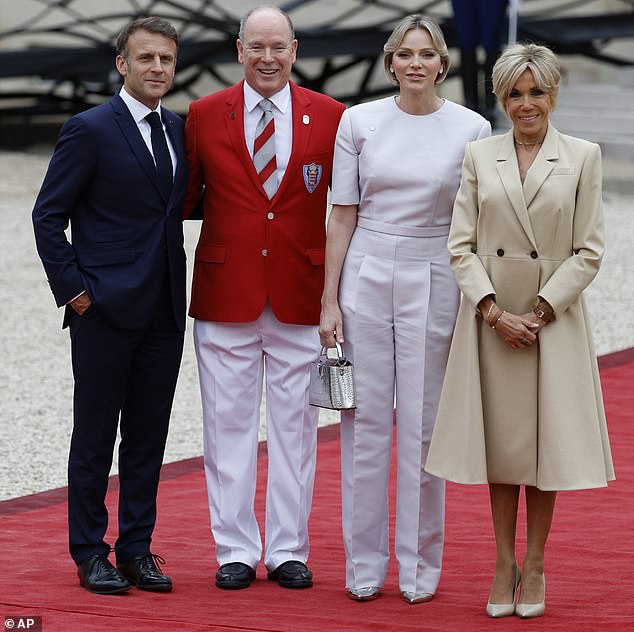 French President Emmanuel Macron and his wife Brigitte Macron, right, welcome Prince Albert II of Monaco and Princess Charlene of Monaco