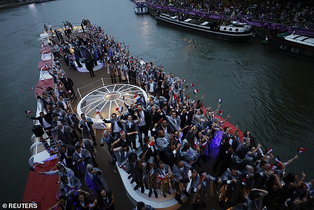 The athletes were taken up the Seine in a flotilla of 85 boats while an interpretive dance took place on the banks.