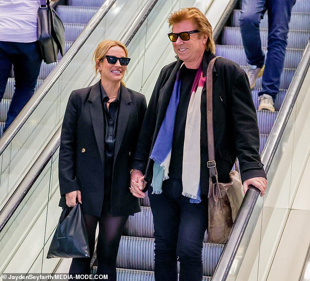 The lovebirds seemed to not have a care in the world as they strolled confidently and in style through the bustling airport.