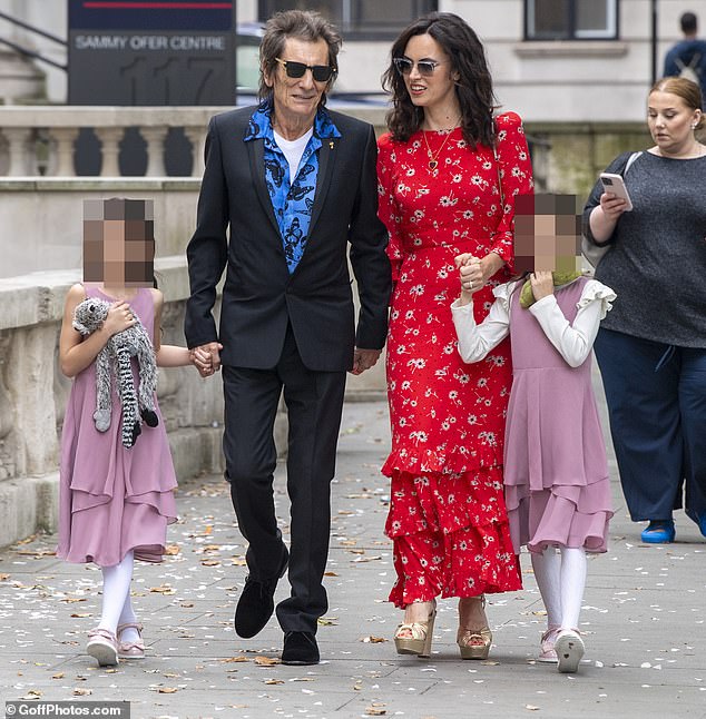 Ronnie walks towards Marylebone Old Town Hall with his eight-year-old twin daughters Grace and Alice and his now wife Sally.