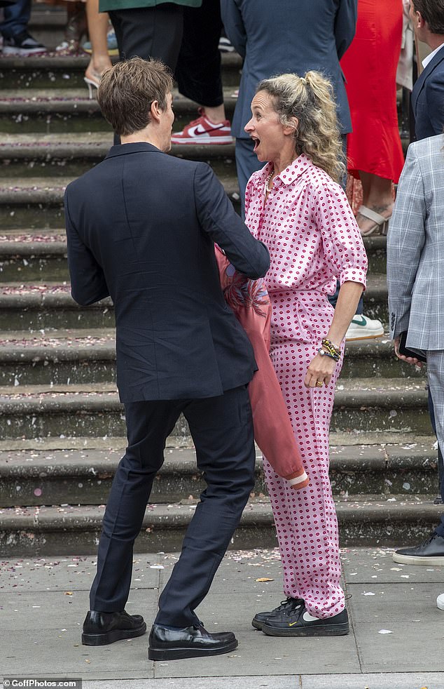 Pictured: Jesse Wood and Leah Wood share a laugh outside the wedding.