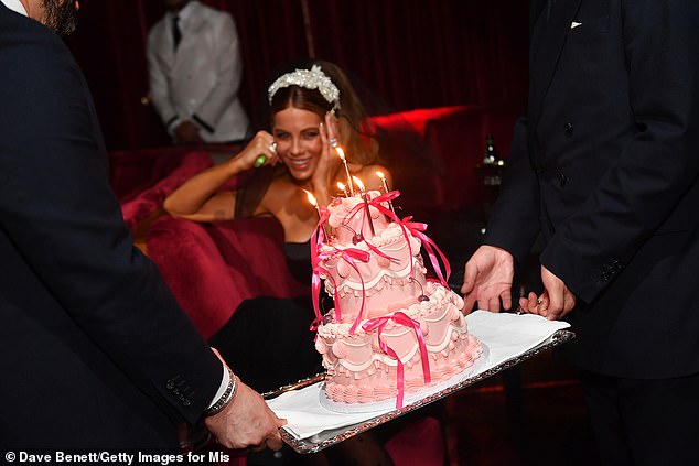 She was surprised with a huge three-tier cake and ended her night mingling with friends and dancing.