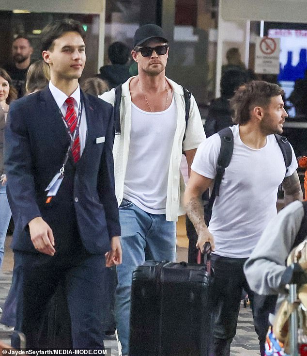 The star was assisted by carers as she made her way out of the airport pushing two suitcases.