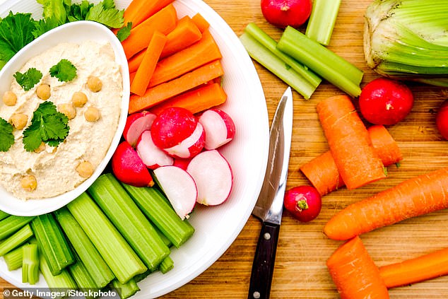 Snacking on hard-boiled eggs, apple slices with a small dollop of nut butter, or some hummus and carrots will keep you 