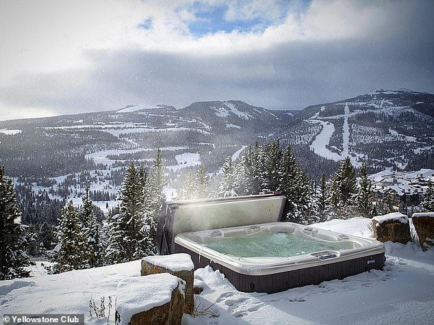 Yellowstone Club members can relax in a hot tub overlooking Montana's snow-capped mountains.