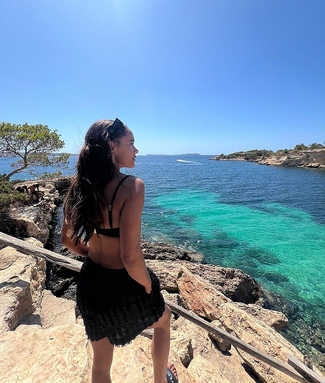 A snap shared by the former footballer includes a photo of herself showing off her toned figure in a black bikini and shorts as she looked out to sea.