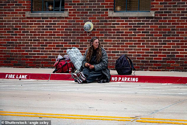 Currently, about 14,000 people in the city are homeless every night. Pictured: A homeless woman sits on the sidewalk of an Oklahoma City street in 2019