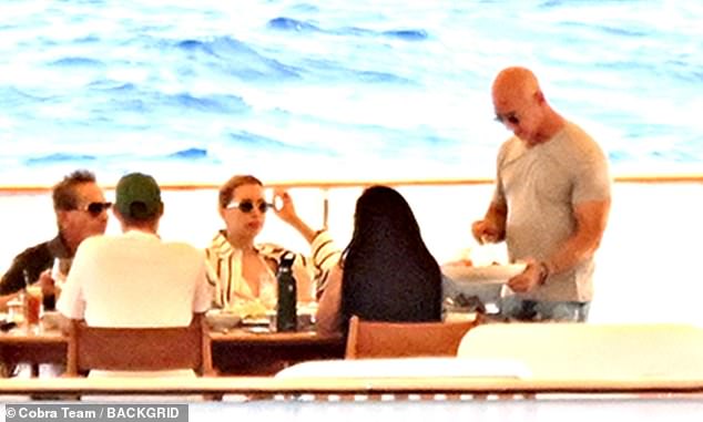 Bezos is seen serving Sanchez dinner and plating her food, showing who is really wearing the pants in the relationship.