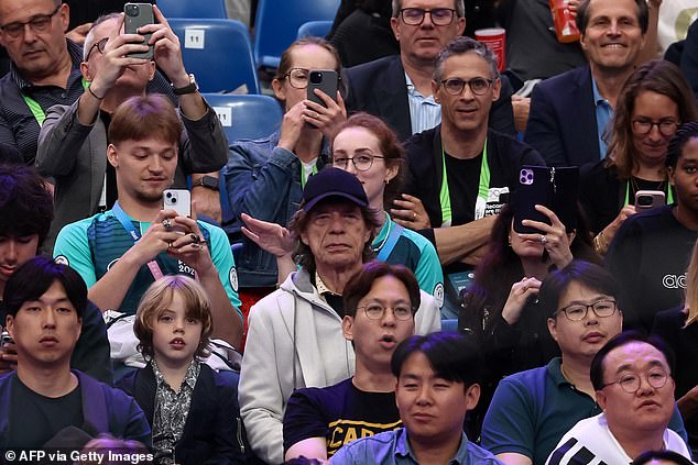 The Rolling Stones rocker went for a low-key outfit with a zip-up hoodie over a jumper, a polka dot shirt and hid his famous locks under a blue baseball cap.