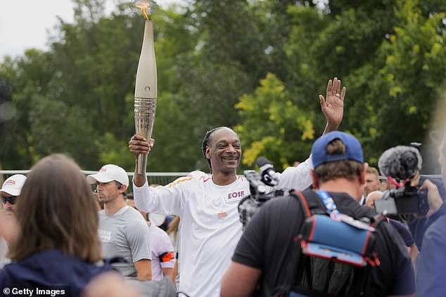 The legendary rapper was one of the people carrying the torch through Paris this week.