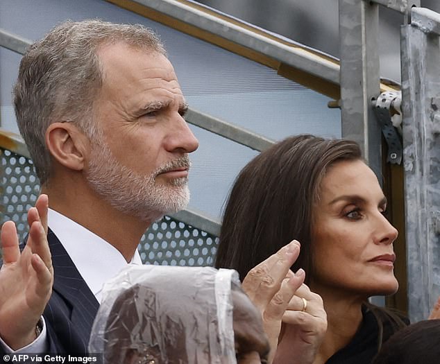 The thunderous expressions on the faces of King Felipe (left) and Queen Letizia of Spain (right) betrayed a longing to escape to the coast.