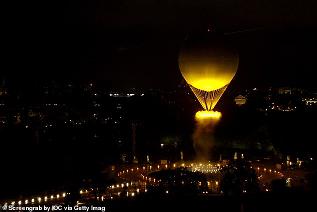 The Olympic flame floats skyward in a golden orb.