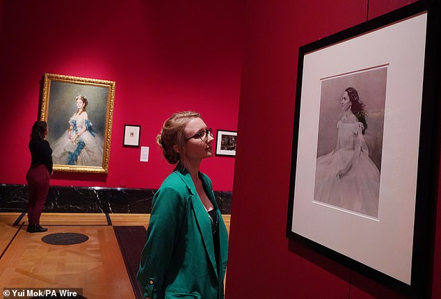 A visitor examines a Paolo Roversi portrait of the Duchess of Cambridge in November 2021