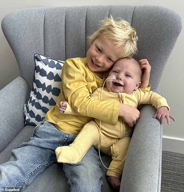 Rocco's father, Chris Kennewell, hopes his family can return home to spend their final time together with Rocco (pictured, Rocco and his older brother, Arlo)