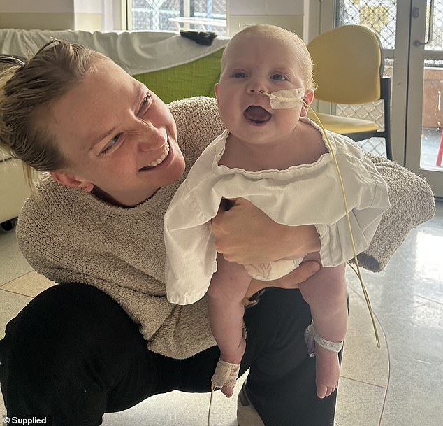 Between 2,400 and 3,000 Australian babies are born each year with congenital heart defects, like Rocco (pictured with Ms Kennewell)