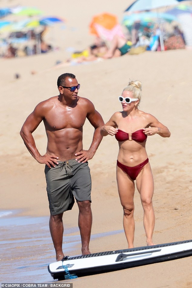 The couple looked devastated as they walked along the beach in Sardinia