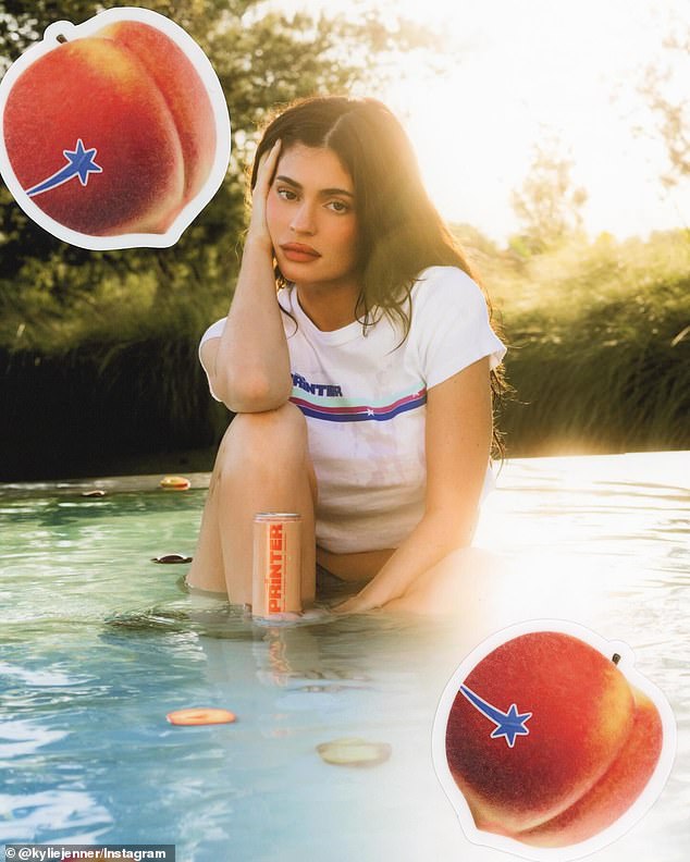 In another image, she is seen sitting in a shallow pool, wearing a T-shirt and holding a can of her drink.