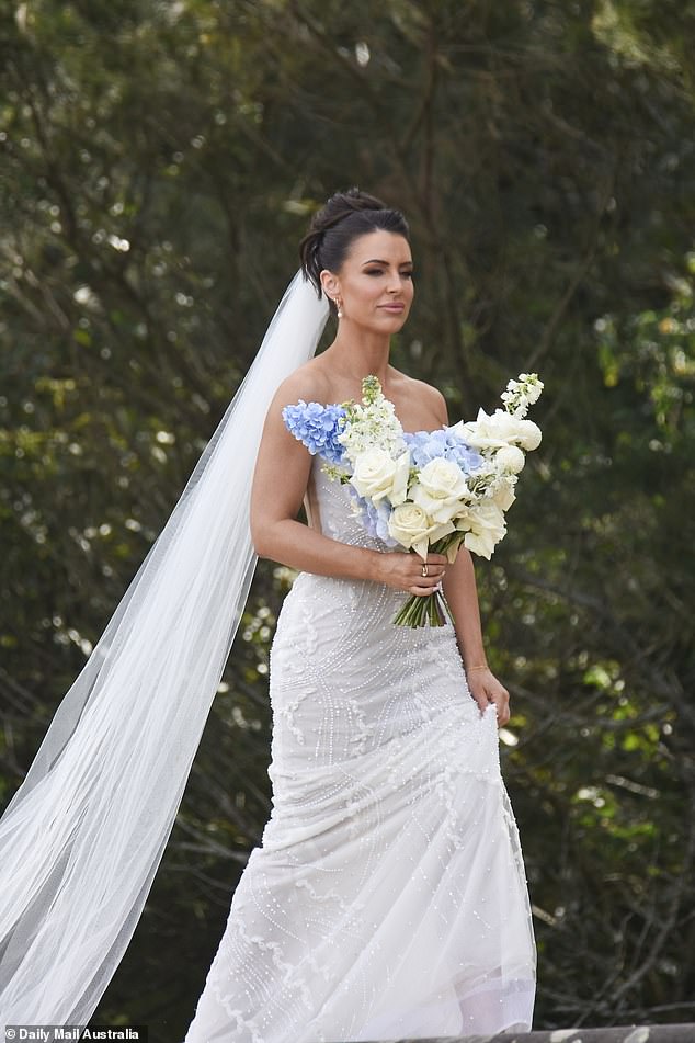 She styled her brunette locks into an elegant updo as her long veil billowed behind her as she looked ready for her big moment.