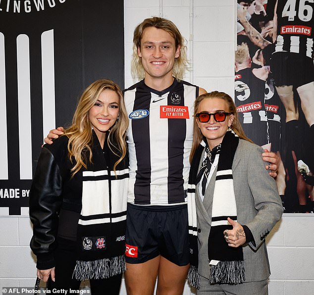 The couple were all smiles as they posed with football stars Isaac Quaynor, Darcy Moore and Mason Cox ahead of their match against Richmond. Pictured here with Darcy Moore.