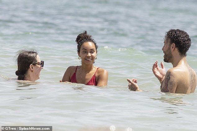 She showed off her smile as she took a dip in the ocean.