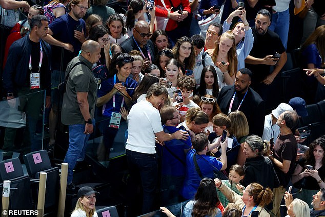 The Mission: Impossible star was guided by security to her seat as she stopped to pose for selfies with several fans.