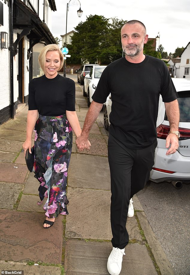 The radiant couple walked together, hand in hand.