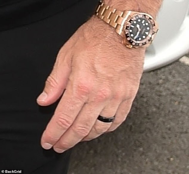 Tom also sported a thick strap that he wore with a striking gold watch.