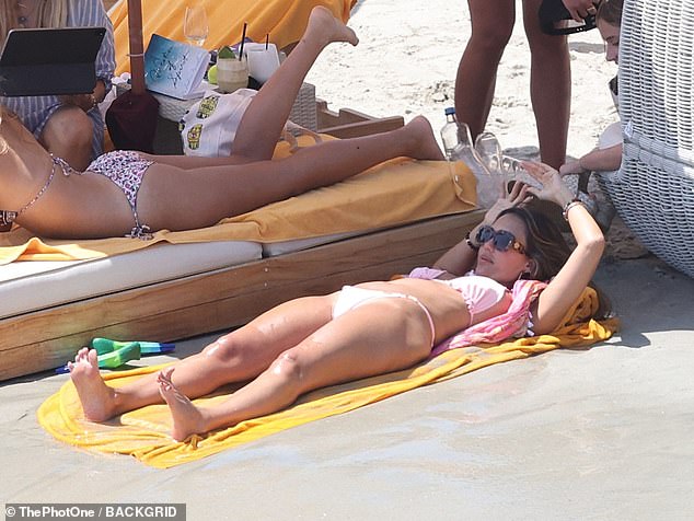 Jessica and Kelly, who usually wear matching Halloween costumes, sunbathed on orange towels as they watched mega yachts sail off the coast.