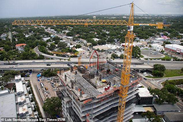 Stable inflation rates in the Florida city are attributed to the great economic development and residential construction in the region. (Pictured: Construction crew works on Tower II of The Ritz-Carlton Residences on July 17)