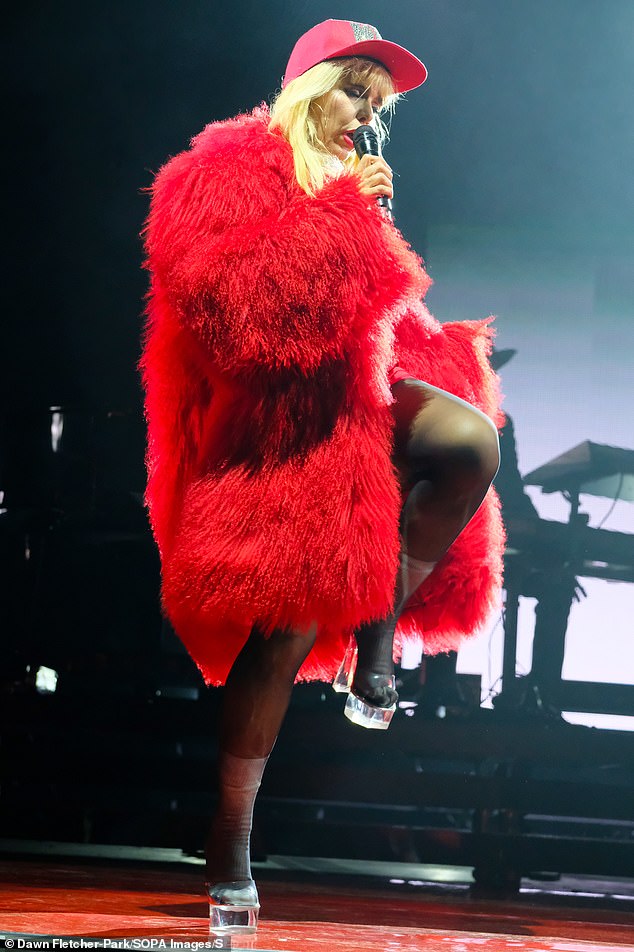 She completed her onstage ensemble with a huge feather coat and strutted around in a pair of clear acrylic heels.