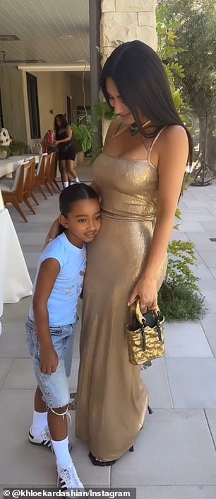 The playful moment was shared with Kim's six-year-old daughter Chicago, who clung to her glamorous mom's hip throughout the snippet.