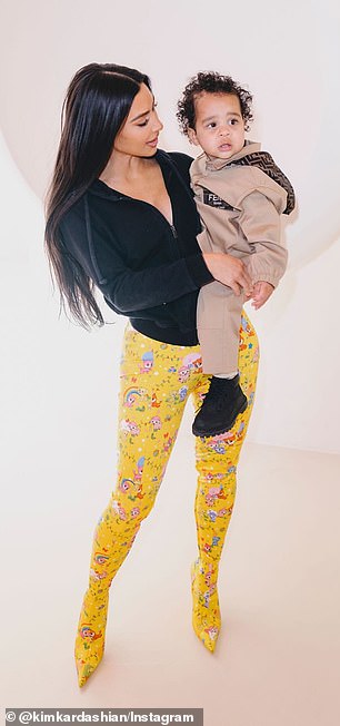 Several snaps showed Kardashian wearing yellow patterned leggings and a black zip-up hoodie as she held Tatum on her hip.