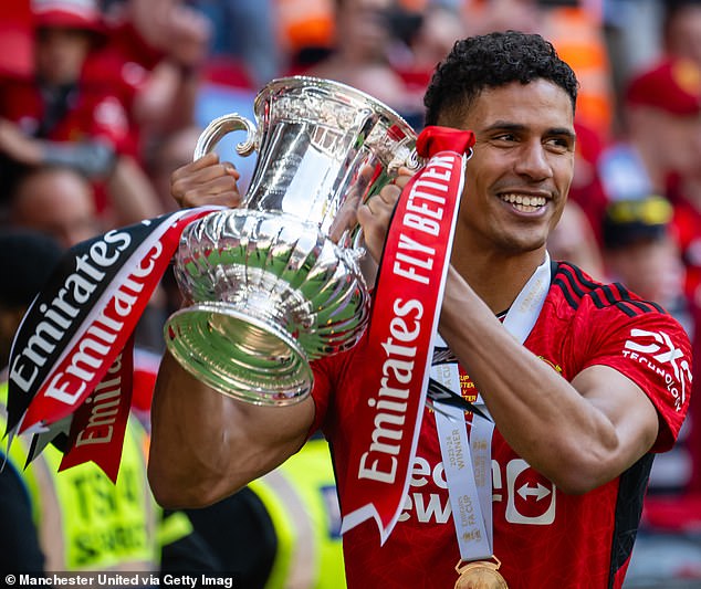 Varane celebrates winning the FA Cup with United before leaving as a free agent a month later