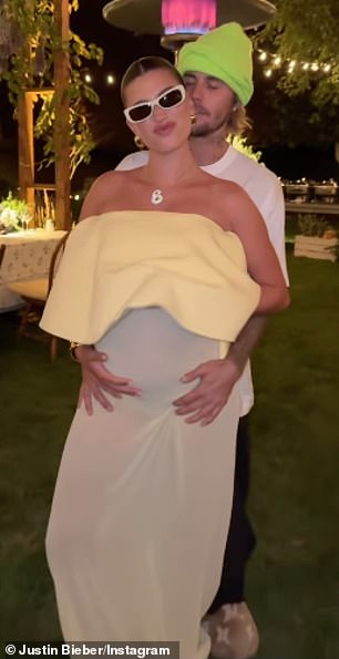 The runway model, who is currently expecting her first child with Justin, revealed her massive baby bump in an elegant white evening gown as she attended an al fresco dinner party.