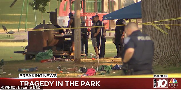 Local police inspect the shooting site and a giant smoke can be seen